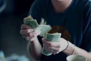 Woman counting money - Northeast Ohio Bankruptcy Attorney